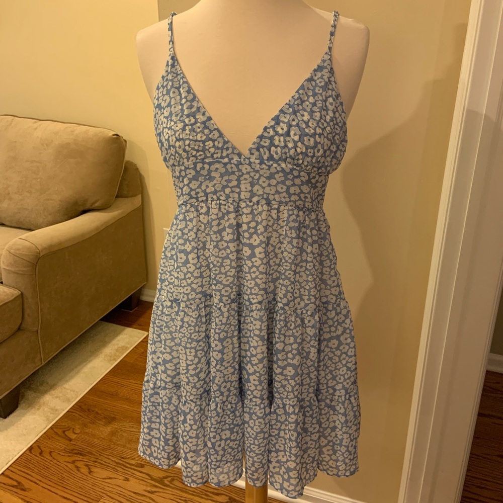 Floral blue and white dress-never worn. 100% polyester - can easily be washed.